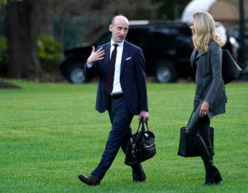 Kayleigh McEnany and White House senior adviser Stephen Miller walk across the South Lawn