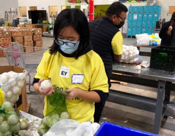 Workers pack onions at a food bank.