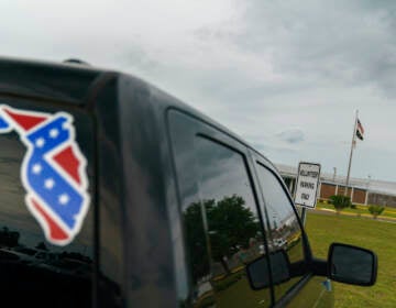  A pickup truck with a Confederate flag-themed decal is parked outside the Reception and Medical Center, the state's prison hospital where new inmates are processed, in Lake Butler, Fla., Friday, April 16, 2021.  (AP Photo/David Goldman, File)