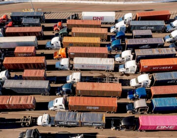 Trucks line up to enter a Port of Oakland shipping terminal on Wednesday, Nov. 10, 2021, in Oakland, Calif. Intense demand for products has led to a backlog of container ships outside the nation's two largest ports along the Southern California coast. (AP Photo/Noah Berger)