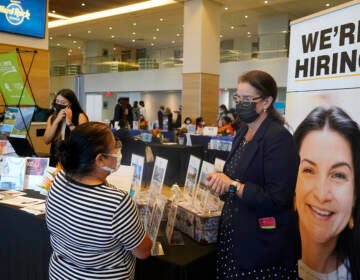 FILE - Marriott human resources recruiter Mariela Cuevas, left, talks to Lisbet Oliveros, during a job fair at Hard Rock Stadium, Friday, Sept. 3, 2021, in Miami Gardens, Fla.  Americans quit their jobs at a record pace for the second straight month in September, while businesses and other employers continued to post a near-record number of available jobs.  (AP Photo/Marta Lavandier, File)