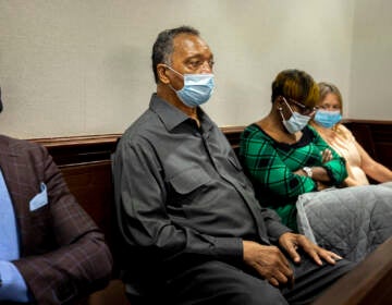 The Rev. Jesse Jackson, center, sits with Ahmaud Arbery's mother, Wanda Cooper-Jones, center right, during the trial of Greg McMichael and his son, Travis McMichael, and a neighbor, William 
