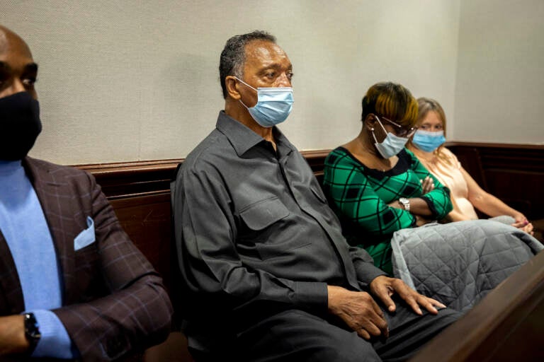 The Rev. Jesse Jackson, center, sits with Ahmaud Arbery's mother, Wanda Cooper-Jones, center right, during the trial of Greg McMichael and his son, Travis McMichael, and a neighbor, William 