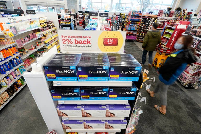 Boxes of BinaxNow home COVID-19 tests made by Abbott and QuickVue home tests made by Quidel are shown for sale Monday, Nov. 15, 2021, at a CVS store in Lakewood, Wash., south of Seattle. After weeks of shortages, retailers like CVS say they now have ample supplies of rapid COVID-19 test kits, but experts are bracing to see whether it will be enough as Americans gather for Thanksgiving and new outbreaks spark across the Northern and Western states