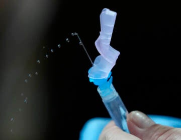 A health worker prepares PfizerÅfs COVID-19 vaccine at the National Kidney and Transplant Institute in Quezon city, Philippines on Wednesday, Nov. 17, 2021. TThe government has started inoculating booster shots to fully vaccinated frontline workers as it eases health restrictions while active COVID-19 cases continue to decline in the country