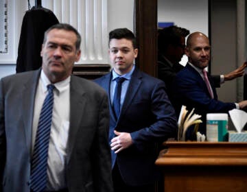 Kyle Rittenhouse, center, enters the courtroom with his attorneys Mark Richards, left, and Corey Chirafisi for a meeting called by Judge Bruce Schroeder at the Kenosha County Courthouse in Kenosha, Wis., on Thursday, Nov. 18, 2021.  (Sean Krajacic/The Kenosha News via AP, Pool)