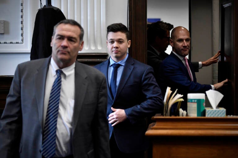 Kyle Rittenhouse, center, enters the courtroom with his attorneys Mark Richards, left, and Corey Chirafisi for a meeting called by Judge Bruce Schroeder at the Kenosha County Courthouse in Kenosha, Wis., on Thursday, Nov. 18, 2021.  (Sean Krajacic/The Kenosha News via AP, Pool)