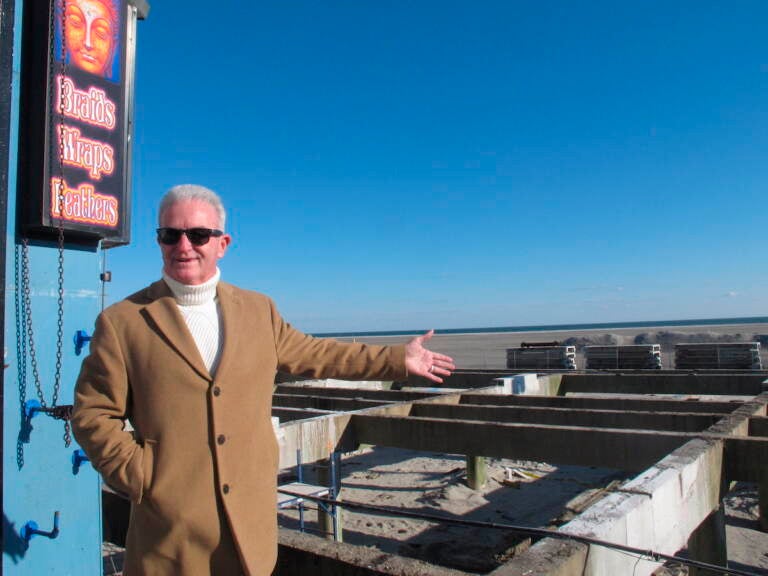 In this Nov. 19, 2021 photo, Wildwood N.J. Mayor Pete Byron gestures toward a section of the Wildwood, N.J. boardwalk that is being rebuilt. The popular seaside town is repairing or rebuilding most of its century-old boardwalk over the next five years