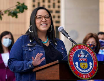 File photo: Colorado State Sen. Julie Gonzales speaks during a news conference on Oct. 15, 2020, in Denver. According to an analysis by The Associated Press, at least 18 states refer to immigrants as 