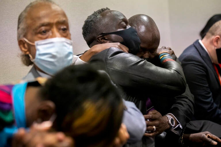 Ahmaud Arbery's father Marcus Arbery, center, his hugged by his attorney Benjamin Crump after the jury convicted Travis McMichael in the Glynn County Courthouse, Wednesday, Nov. 24, 2021, in Brunswick, Ga.  Greg McMichael and his son, Travis McMichael, and a neighbor, William 