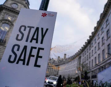 A sign reading ’Stay safe’ in Regent Street, in London, Friday, Nov. 26, 2021. A slew of nations moved to stop air travel from southern Africa on Friday, and stocks plunged in Asia and Europe in reaction to news of a new, potentially more transmissible COVID-19 variant