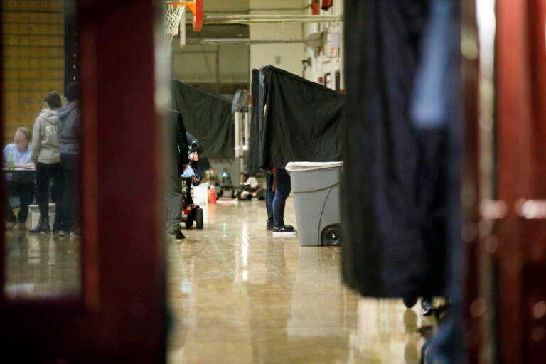 Voters cast their vote at South Philadelphia High School before polls close during the general election on Tuesday, November 2, 2021. Voters continue to cast their votes before the polls close and despite the rain