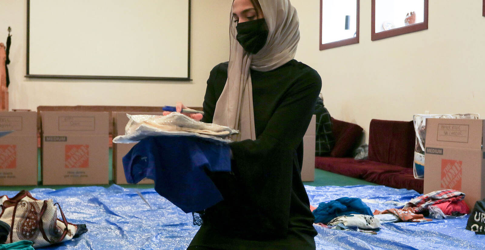 Sarah Ahmad, a mosque attendee from Moorestown, folding clothing donations.
A donation pack up for incoming Afghan refugees run by AOPxSOLA and members of Imam Ali Masjid Mosque at Imam Ali Masjid Mosque in Pennsauken, NJ on 11/14/21.
[DANIELLA HEMINGHAUS]