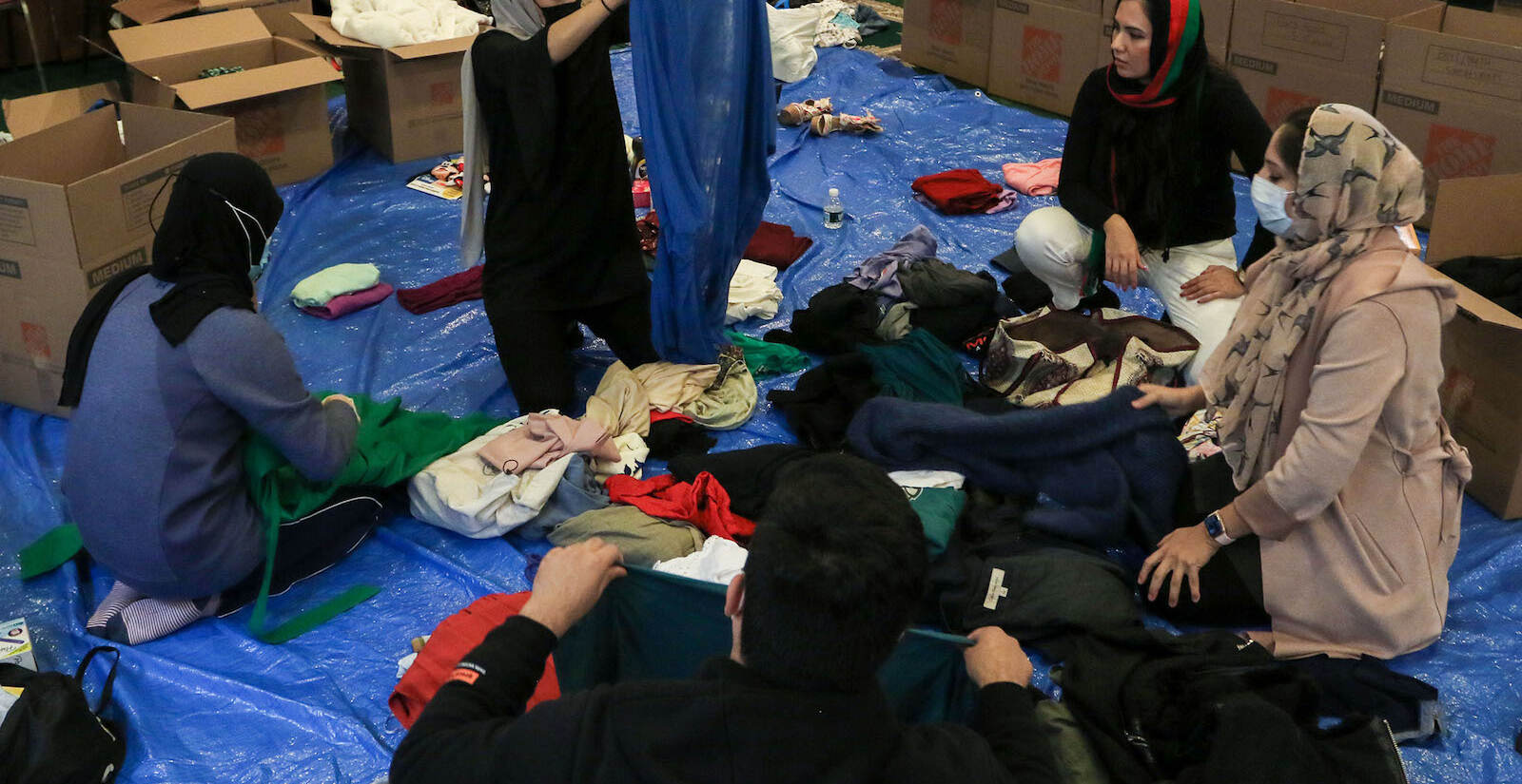 Mosque attendees and AOPxSOLA members folding clothing donations.
A donation pack up for incoming Afghan refugees run by AOPxSOLA and members of Imam Ali Masjid Mosque at Imam Ali Masjid Mosque in Pennsauken, NJ on 11/14/21.
[DANIELLA HEMINGHAUS]