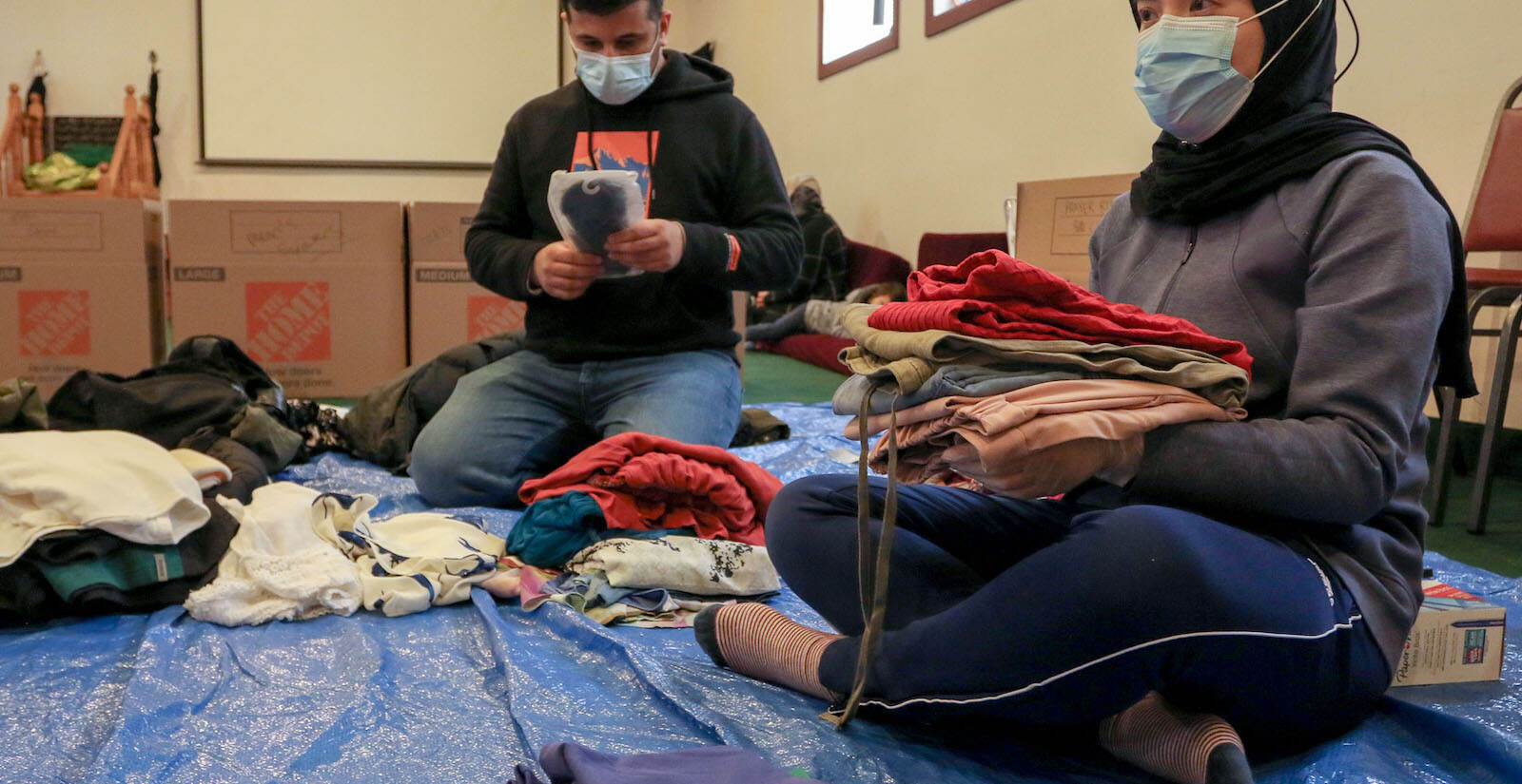 Mir Temory, from Bensalem, and Hung Kong, from Levittown, folding clothing donations.
A donation pack up for incoming Afghan refugees run by AOPxSOLA and members of Imam Ali Masjid Mosque at Imam Ali Masjid Mosque in Pennsauken, NJ on 11/14/21.
[DANIELLA HEMINGHAUS]