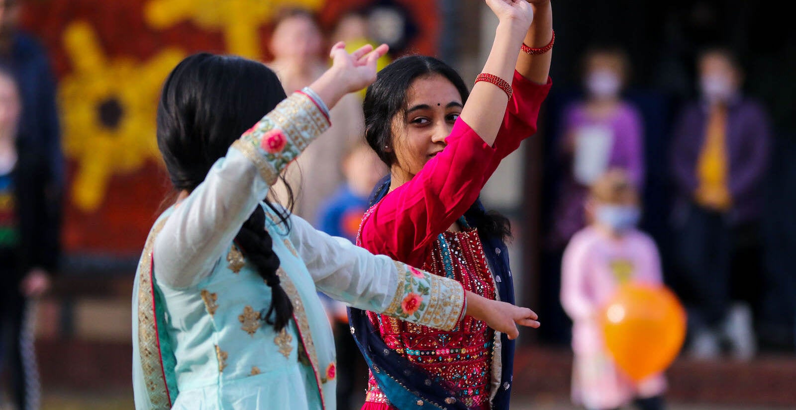 Saanvi Potnis (left) and Arya Haridas (right), of Doylestown, dancing at the first annual Diwali festival in Doylestown on Nov. 7, 2021. (Daniella Heminghaus for WHYY)