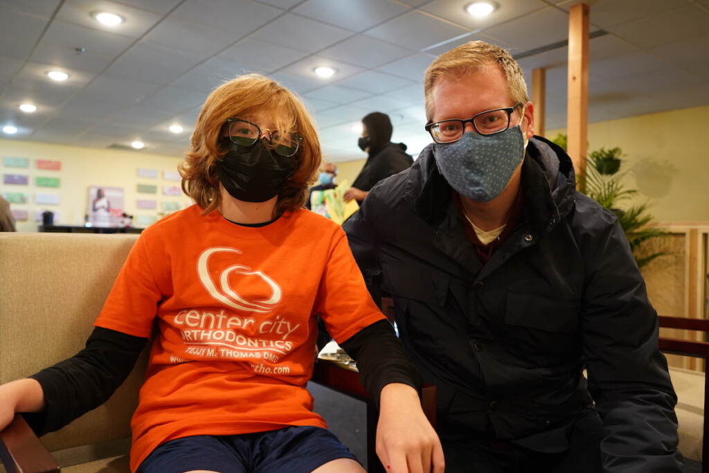 Jo (L) and Joe Sirbak (R) filled out the forms as they waited for the doctor to call Jo's name at the Black Doctors COVID-19 Consortium’s first weekend of vaccinations for younger children at the Dr. Ala Stanford Center for Health Equity (ASHE) in North Philadelphia