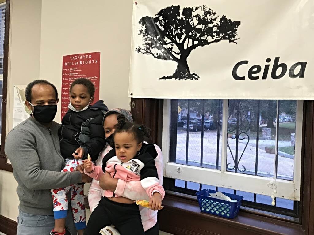 Jose and Rosa hold their children, Helen and Patrick, after getting tax help at Ceiba's office in Kensington, Philadelphia.