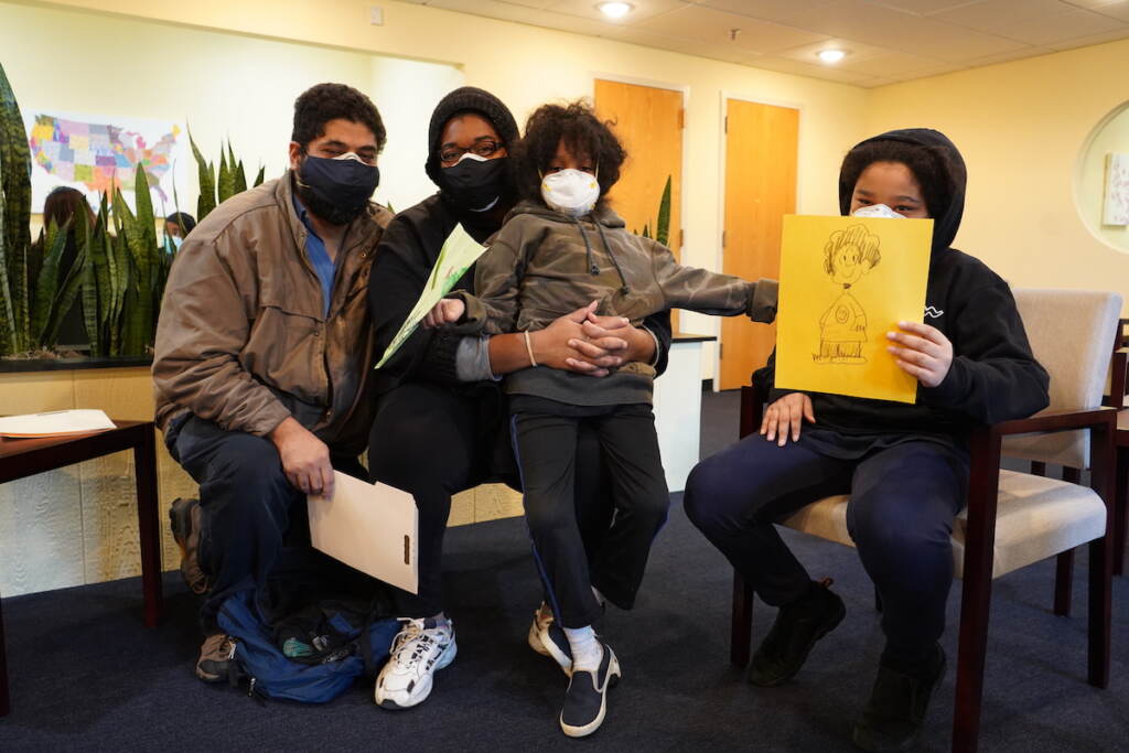 The Rapaport family as they sit tight in the waiting room of the Black Doctors COVID-19 Consortium’s first weekend of vaccinations for younger children at the Dr. Ala Stanford Center for Health Equity (ASHE) in North Philadelphia
