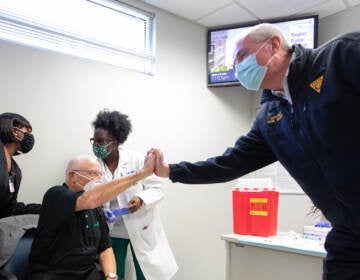 Oct. 28, 2021: Gov. Phil Murphy, right, at a clinic for COVID-19 vaccination booster shots in Trenton. (Rich Hundley/NJ Spotlight News)