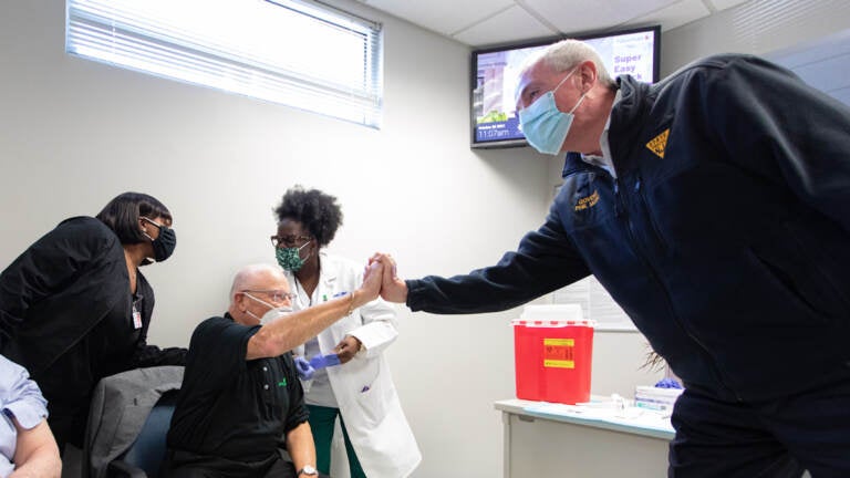 Oct. 28, 2021: Gov. Phil Murphy, right, at a clinic for COVID-19 vaccination booster shots in Trenton. (Rich Hundley/NJ Spotlight News)