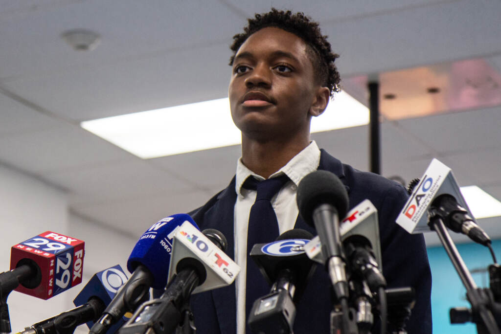 Jaylin Heath speaks from a podium during a press conference