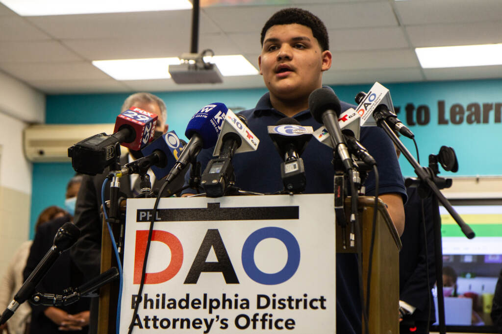 Herman Andino speaks from a podium during a press conference