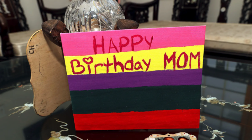 A wooden birthday card Christian made for Fe Hall still sits in their living room. (Fred Adams for Spotlight PA)