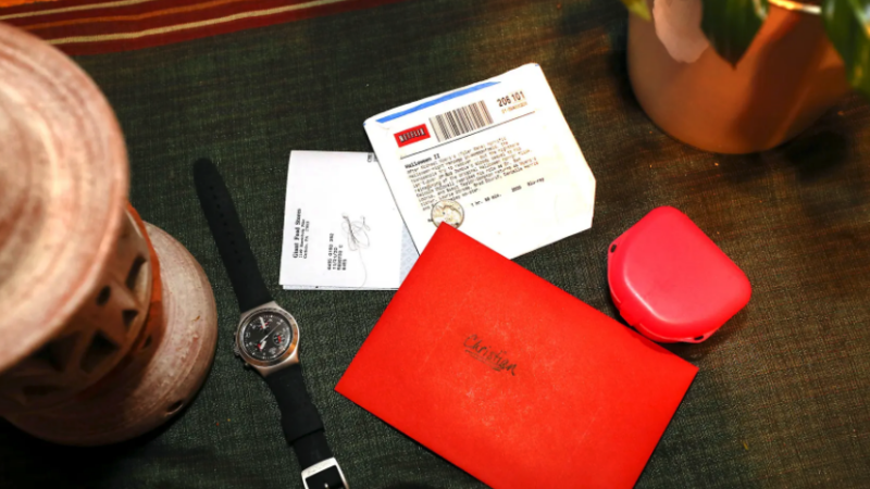 A change wallet, rental DVD, watch, and Christmas card left behind by Christian. (Fred Adams for Spotlight PA)