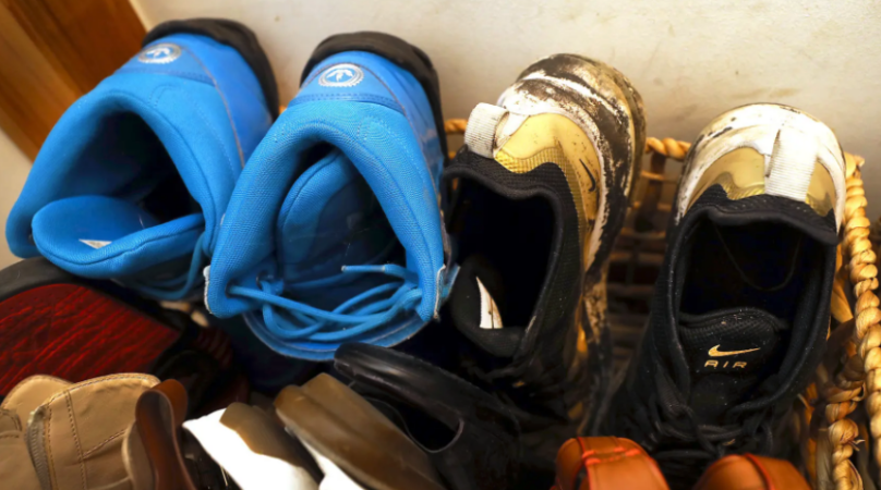 Christian’s shoes remain stored in a basket. (Fred Adams for Spotlight PA)