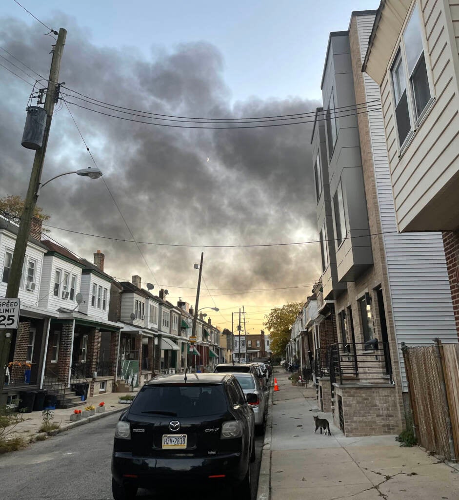 Smoke from a fire at Delaware Valley Recycling rises above homes in Grays Ferry