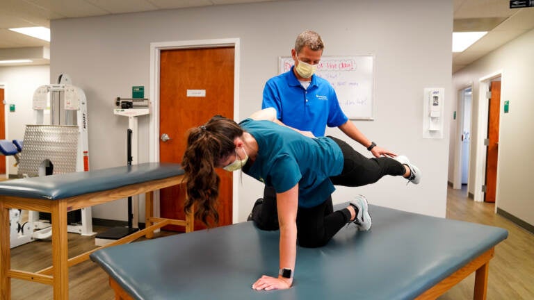 Brian Catania works aide Taylor Putnam through the Row Dog, one of the six core activation exercises he and Travis Ross developed.