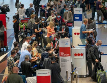 People line up to get on a flight