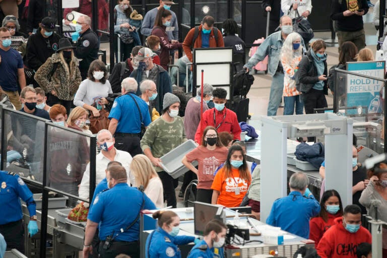 People line up for a TSA checkpoint at an airport