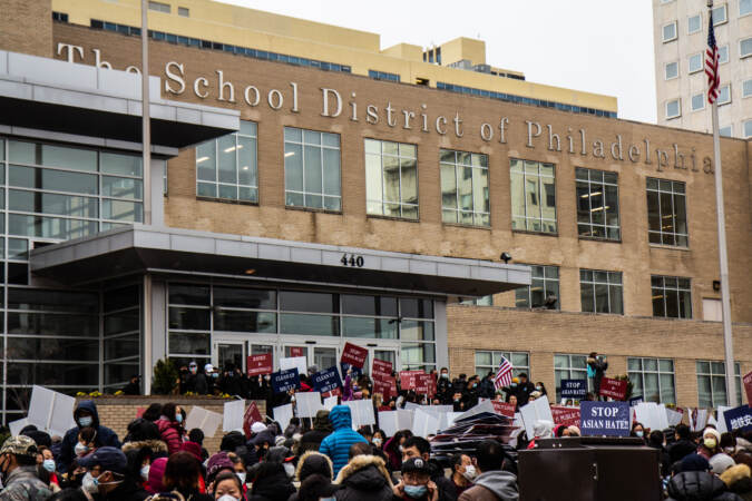 Protesters rally outside the School District of Philadelphia headquarters, with signs visible that say, 