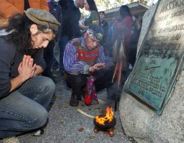 Supporters of Native Americans pause following a prayer during the 38th National Day of Mourning at Coles Hill in Plymouth, Mass., on Nov. 22, 2007. Denouncing centuries of racism and mistreatment of Indigenous people, members of Native American tribes from around New England will gather on Thanksgiving 2021 for a solemn National Day of Mourning observance. (AP Photo/Lisa Poole, File)