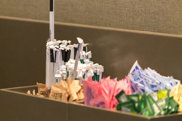 NEW YORK, USA - MAY 15, 2019: Counter in Starbucks cafe with Straws and sugar to pick up to go