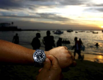 People are seen adjusting the clock during the summer time period in Salvador, Brazil