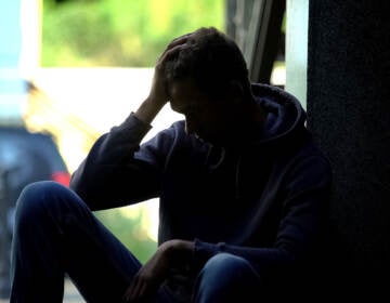 Depressed teen sitting in the dark