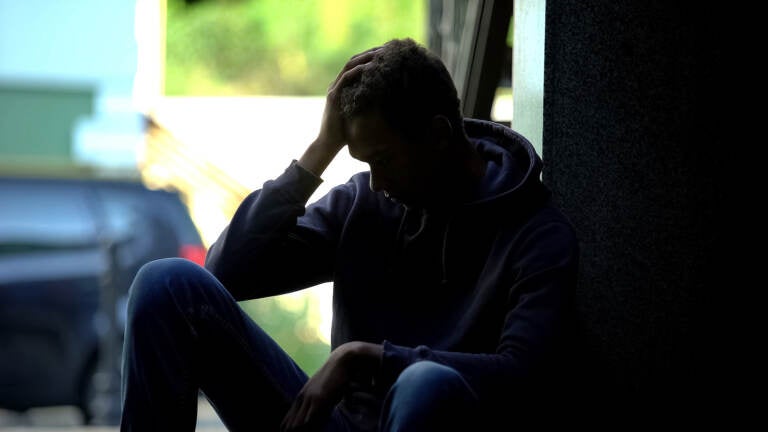 Depressed teen sitting in the dark