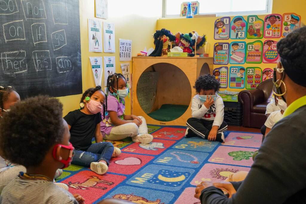 Tanisha Baylor (right) during “circle time” with other 4-year-old students