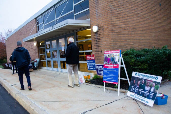 Juxtaposed Republican and Democrat school board nominee posters on display outside Pennridge South Middle School
