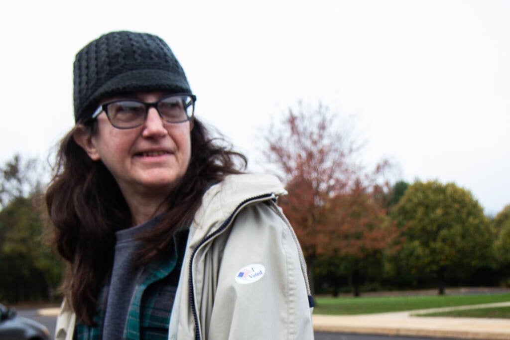 Diana Long stands outside with an "I Voted" sticker on her jacket