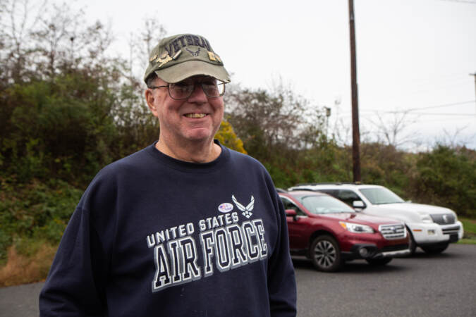 Bruce Cavanagh smiles for a photo outside his polling place