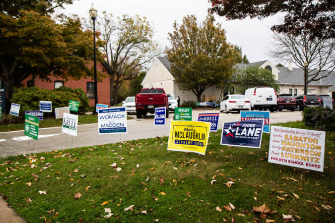 Campaign signs are pictured on a lawn outside