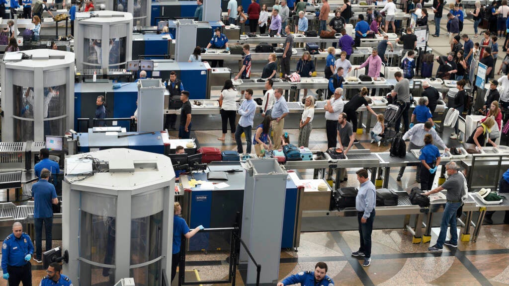 Airplane passengers line up for TSA security screenings