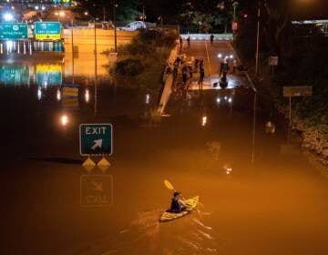 A kayaker paddles down a portion of I-676