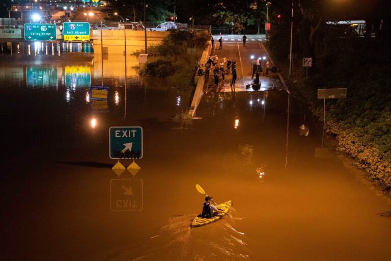 A kayaker paddles down a portion of I-676