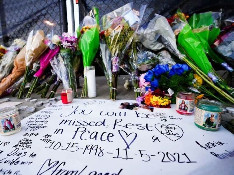 Candles, flowers and letters were placed at a memorial outside the canceled Astroworld music festival at NRG Park in Houston on Sunday. Candles, flowers and letters are placed at a memorial