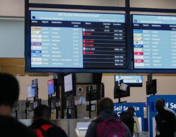 Travellers walk near an electronic flight notice board displaying cancelled flights  at OR Tambo International Airport in Johannesburg on November 27, 2021, after several countries banned flights from South Africa following the discovery of a new Covid-19 variant Omicron. - A flurry of countries around the world have banned ban flights from southern Africa following the discovery of the variant, including the United States, Canada, Australia,Thailand, Brazil and several European countries. The main countries targeted by the shutdown include South Africa, Botswana, eSwatini (Swaziland), Lesotho, Namibia, Zambia, Mozambique, Malawi and Zimbabwe. (Photo by Phill Magakoe / AFP) (Photo by PHILL MAGAKOE/AFP via Getty Images)